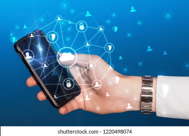 Hand using phone with centralized cloud computing system and network security concept