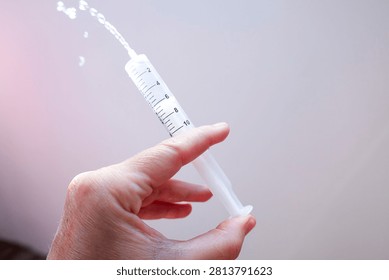 Hand Using Plastic Syringe Expelling Liquid – Medical Concept