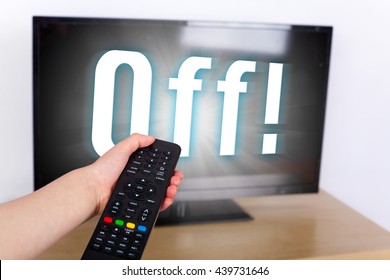 Hand Using A Remote Control To Turn Off The TV