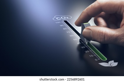 Hand using a slider to reduce CO2 emissions. Carbon free energy. Concept of decarbonization. - Shutterstock ID 2256892601