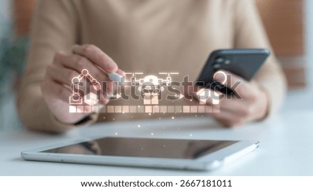 Hand using smart devices with icons of robotic packaging, drone delivery, and home shipping. Concept of automation, supply chain, and smart logistics system.