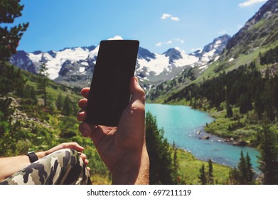 Hand using smartphone on blur landscape view. phone with copy space for text