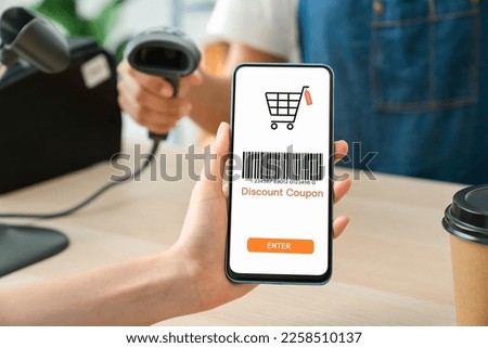 Hand using smartphone with scan barcode for discount code coupon, shopping online, Digital wallet concept.