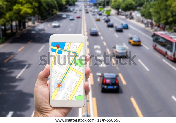 Hand using\
smartphone searching location on satellite navigation application\
and network connection over traffic transportation in\
city,satellite navigation system app\
concept