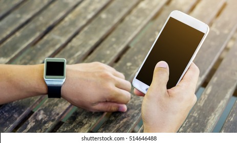 hand using a smartphone and a smartwatch. - Shutterstock ID 514646488