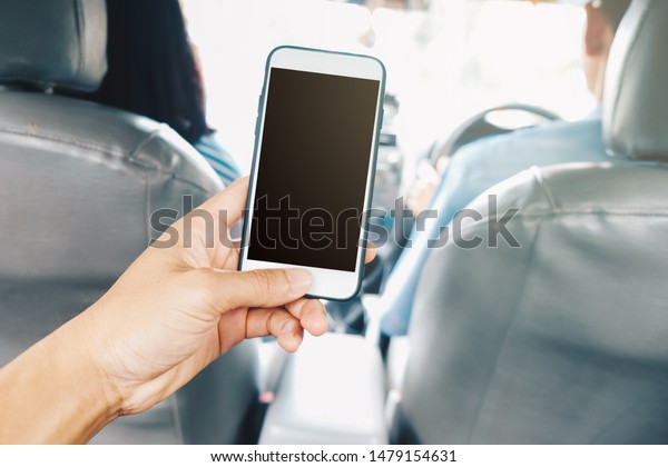 Hand using smartphone in taxi car blank screen
transport business
