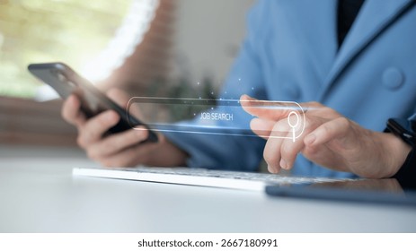 Hand using a smartphone and typing on a keyboard with a virtual job search bar. Concept of online job hunting, digital recruitment, and modern employment search tools.