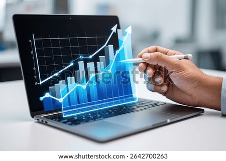 Hand using a stylus to interact with a laptop displaying a vibrant, upward-trending graph, symbolizing growth and success.
