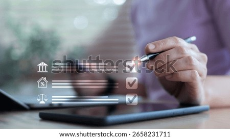 Hand using a stylus on a tablet with digital checklist icons for banking, mortgage, and tax, representing financial management, digital approval, and planning process.