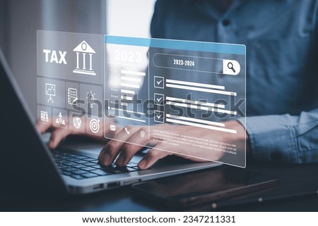 Hand using tablet with bar  TAX REFUND and refund tax of duty taxation business, graphs and chart being demonstrated on the screen media,  tablet pc and selecting tax refund.