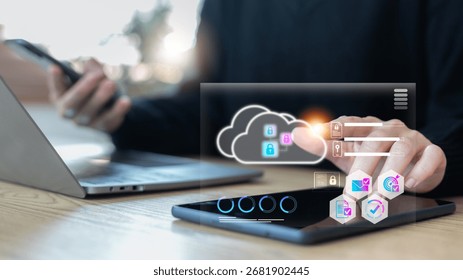 Hand using tablet with cloud storage and security lock icons, data protection, cybersecurity, online safety, and cloud computing technology for secure digital business solutions.