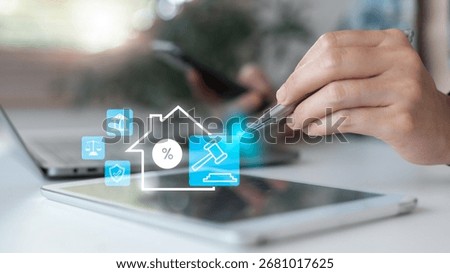 Hand using a tablet with digital real estate law icons, property tax, mortgage, housing finance, legal technology, home insurance, justice system, and secure investment in the real estate business.