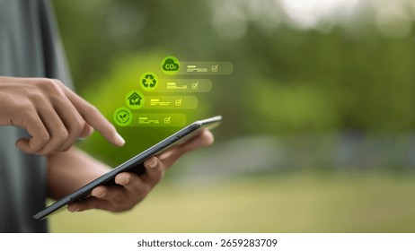 Hand using tablet with floating ESG icons including CO2, recycle, home, and leaf. Concept of sustainability, carbon footprint tracking, and eco digital innovation.