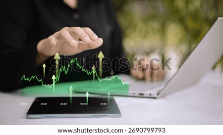 Hand using tablet with glowing green line chart and upward arrows. Mobile trading, stock market growth, investment analytics, real-time data, portfolio performance, forex and crypto analysis.