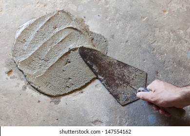 Hand Using Trowel  With Wet Concrete Floor