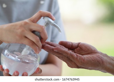 Hand using wash hand sanitizer gel pump dispenser. Clear sanitizer in pump bottle, for killing bacteria and virus. Selective focus. - Powered by Shutterstock