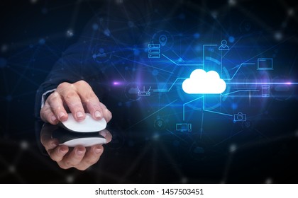 Hand using wireless mouse in a dark environment with cloud technology and online storage concept - Powered by Shutterstock