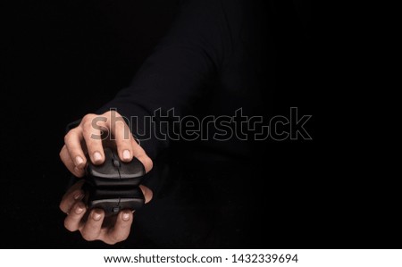 Hand using wireless mouse in a dark environment