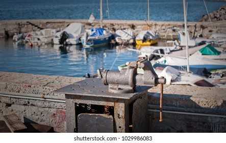 Hand vise on metal bench on blurred harbor in background. - Shutterstock ID 1029986083