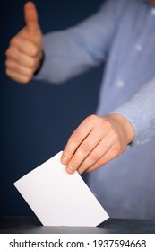 Hand Of A Voter Putting Vote In The Ballot Box. Election Concept.