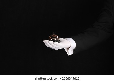 hand of a waiter with a service call on a black background