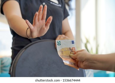 Hand Of The Waitress Refuses To Receive 50 Euro Tip. The Waitress Refuses To Receive A Tip From The Client In The Hotel Bar. The Girl Is Frustrated. The Concept Of Service.                            