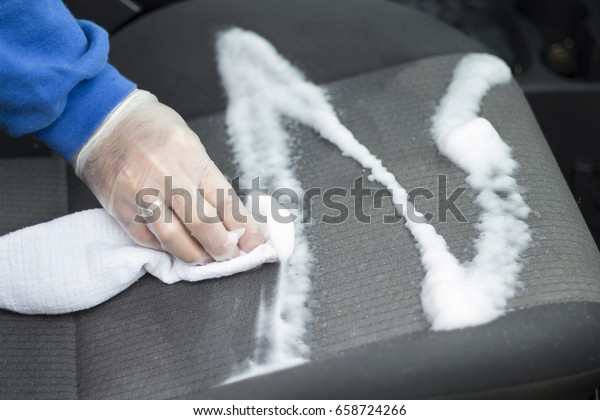 Hand\
wash car upholstery with washing foam and\
sponge.