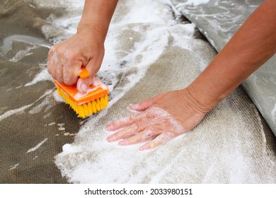 Hand wash carpet. Washing. Close-up. Background. - Shutterstock ID 2033980151