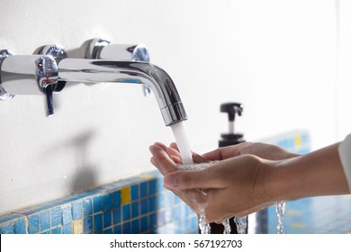 Hand washing in the bathroom at home,water sinks.