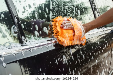 Hand  Washing A Car With Sponge 