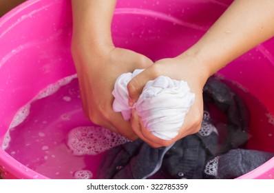 Hand Washing Clothes In The Basin.