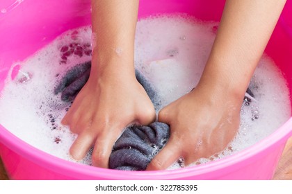 Hand Washing Clothes In The Basin.