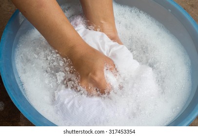 Hand Washing Clothes In The Basin Blue.