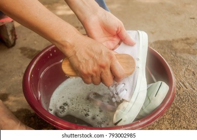 The Hand Washing A Dirty White Shoes At Home