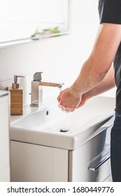 Hand washing with soap in bathroom to prevent contamination, close up - Shutterstock ID 1680449776