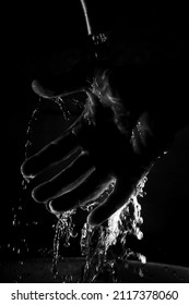 Hand In Water On Black Background