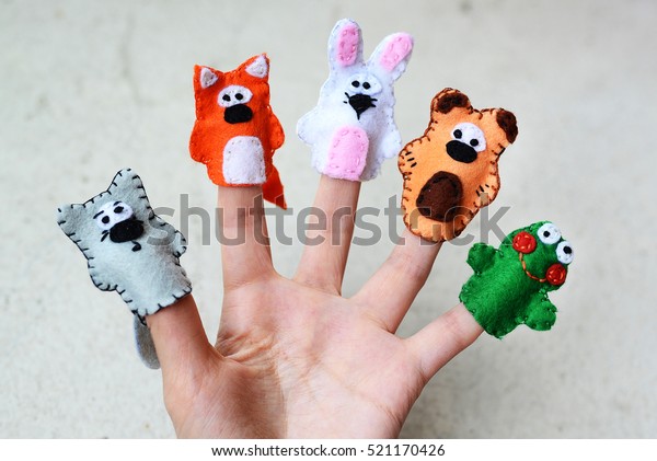Hand wearing 5 finger puppets; wolf, fox, rabbit,\
bear, frog