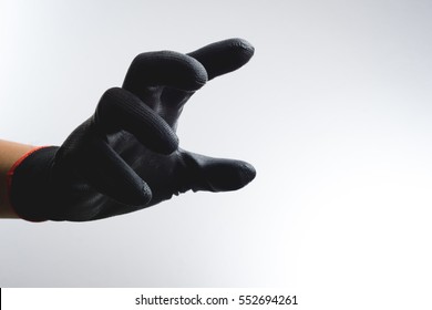 A Hand Wearing Black Glove With Action Gesture