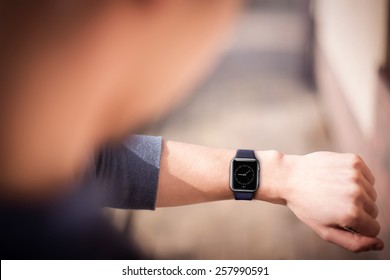 Hand wearing elegant smartwatch with clock app - Powered by Shutterstock