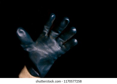 A hand wearing glove with action gesture