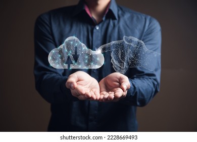 A hand from the web clicks on cloud storage. Man holding in his hand