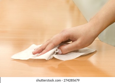 Hand With Wet Wipe Cleaning Table