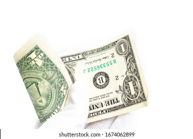 a hand in a white glove holds a one-dollar bill on a white background.