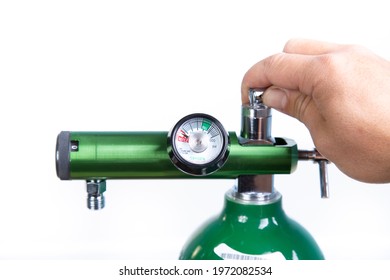 A Hand Of A White Man Open An Oxygen Tank. AN Oxygen Tank Insulated In A White Background