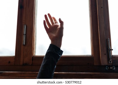 Hand in window