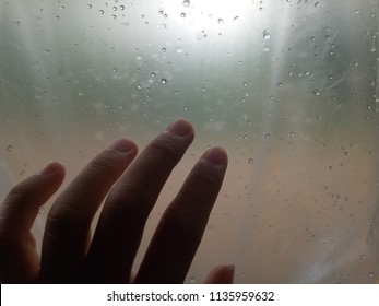 The hand at the window on the raining day, Depression  mood.