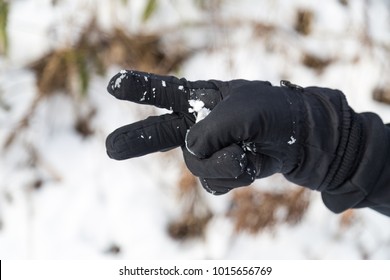 Hand In Winter Glove Gesture Scissor Or Cut On Snow Background