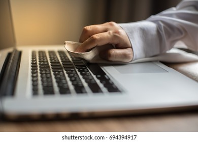 Hand Wiping The Keyboard To Clean The Notebook Computer. Located On The Desk Using The Keyboard Wipes. Selective Focus