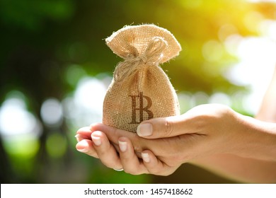 Hand of a woman carrying a purse money .concept saving money and investment concept