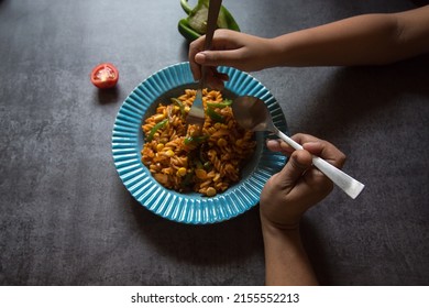 Hand Of A Woman And Child Sharing Food From The Same Plate. Close Up, Selective Focus. Concept Of Sharing Is Caring.